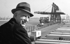 Malcom McLean and port with containers for transport in background